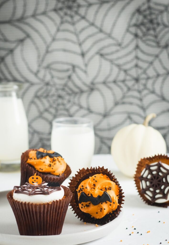 a white plate topped with cupcakes covered in frosting